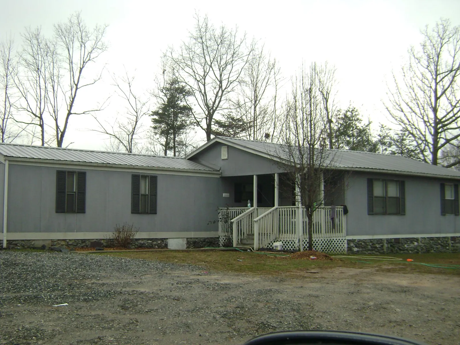 Metal roof over a manufactured home with a covered front porch in Nome